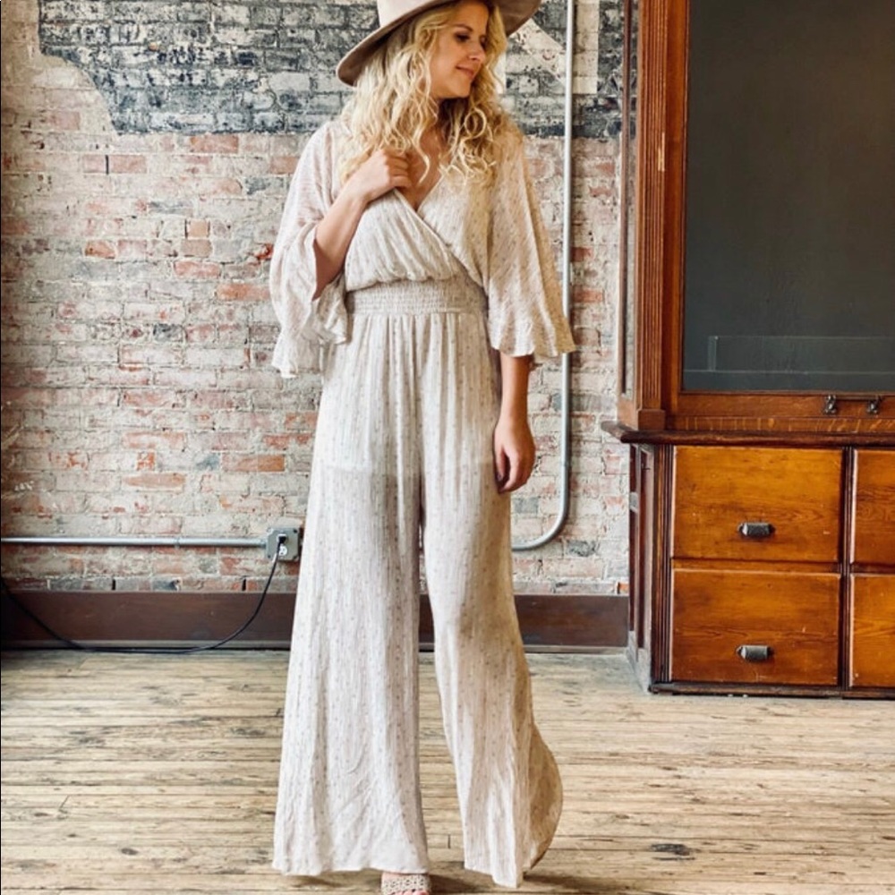 Tan V-neck wide legged jumpsuit.